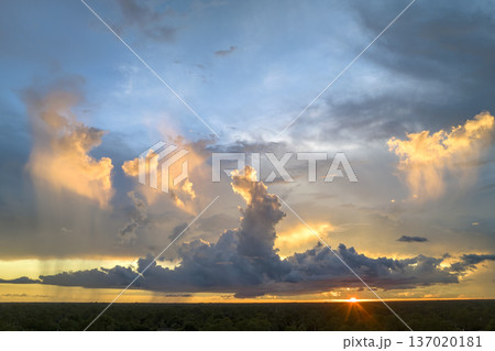 Cumulonimbus clouds forming before thunderstorm on evening sky. Changing stormy cloudscape weather at sunset Cumulonimbus clouds forming before thunderstorm on evening sky. Changing stormy cloudscape weather at sunset 137020181