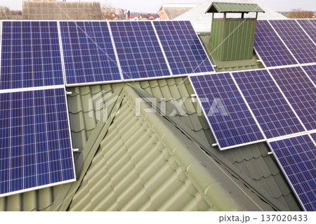 Close-up surface of blue shiny solar photo voltaic panels system on building roof. Renewable ecological green energy production concept. 137020433