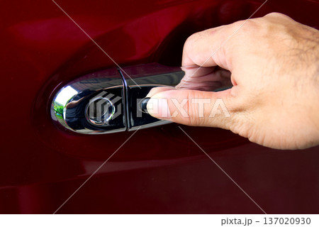 Secure Keyless Car Entry, A hand reaches to press the black button Secure Keyless Car Entry, A hand reaches to press the black button 137020930