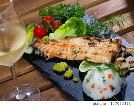 Grilled trout fillet with rice, vegetables, white wine Grilled trout fillet with rice, vegetables, white wine 137023318