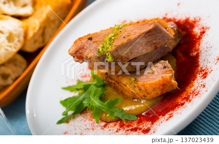 Duck breast on spicy mango sauce with arugula and smoked pepper Duck breast on spicy mango sauce with arugula and smoked pepper 137023439