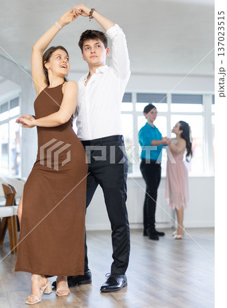 During rehearsal, guy and girl participants of dance workshop perform figure waltz 137023515