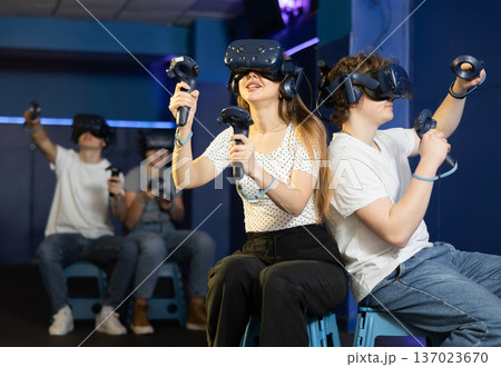 Man and wiman is fascinated by movie in virtual reality glasses Man and wiman is fascinated by movie in virtual reality glasses 137023670