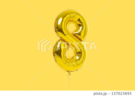 Golden balloon in the shape of number 8 stands out Golden balloon in the shape of number 8 stands out 137023693