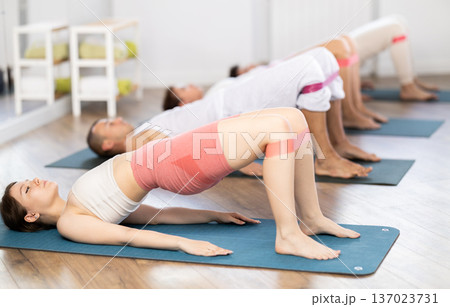 Young girl practicing bridge position with resistance band 137023731