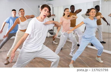 Group of women and men training sport dance in modern studio Group of women and men training sport dance in modern studio 137023798