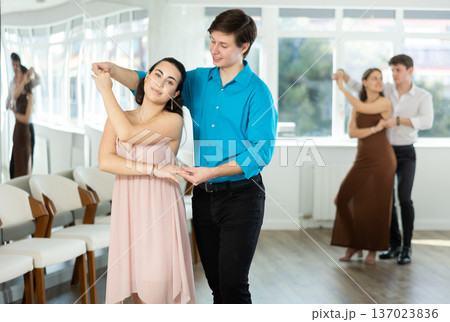 Couple young woman and man dancing waltz Couple young woman and man dancing waltz 137023836