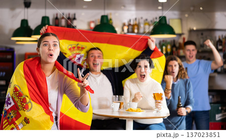 Joyful fans of the Spain team celebrating the victory in night bar 137023851