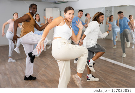 Group of different people rehearsing dance in dance studio 137023855