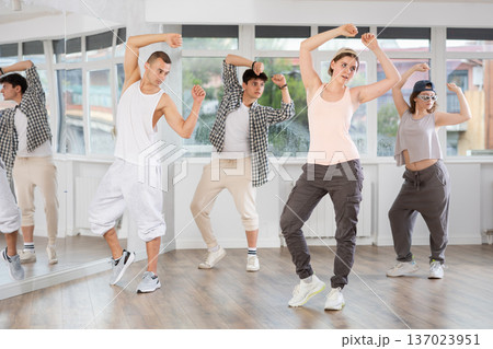 Hip-hop dance performed by group of young dancers in dance studio Hip-hop dance performed by group of young dancers in dance studio 137023951