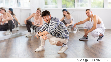 Group of young friends learn group dances - hip-hop and breakdance in dance studio Group of young friends learn group dances - hip-hop and breakdance in dance studio 137023957