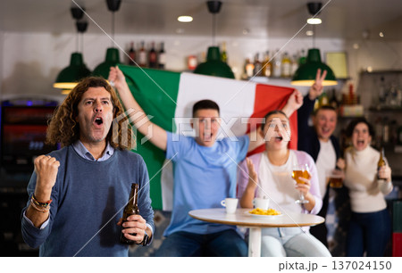 Happy fans celebrating the victory of Italian team in bar 137024150