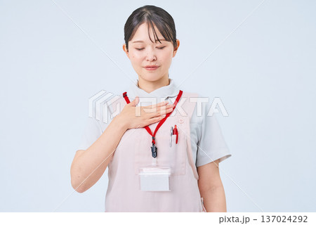 胸に手を当てる白衣の女性 137024292