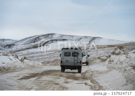 Russian Off-road vans driving on the rough road in Olkhon island for carrying tourist to visit Baikal lake the world's deepest lake located in southern Siberia, Russia. Russian Off-road vans driving on the rough road in Olkhon island for carrying tourist to visit Baikal lake the world's deepest lake located in southern Siberia, Russia. 137024717