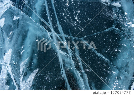 Beautiful cracks surface of the frozen lake Baikal in winter season. Baikal is the largest freshwater lake and the world's deepest lake. 137024777