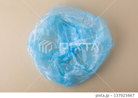 Blue crumpled plastic bag representing waste and environmental pollution 137025667