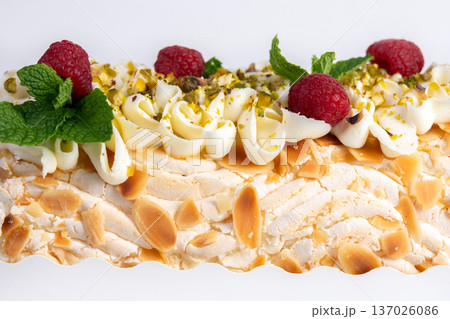 Meringue cream cheese roll with raspberries, mint and nuts. 137026086