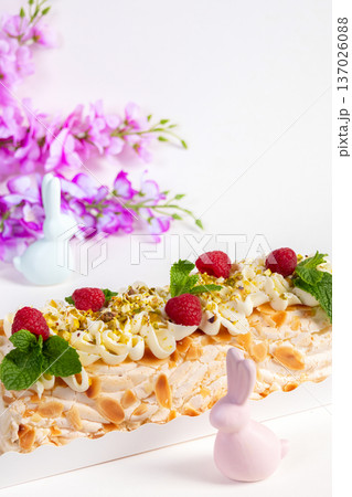 Easter meringue cream cheese roll with raspberries and nuts. Easter meringue cream cheese roll with raspberries and nuts. 137026088