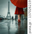 Faceless woman with umbrella walking near Eiffel Tower. Red accent. Romantic city travel. European tourism vacation, French. Destination branding, travel advertising, lifestyle, urban journey concepts 137026219