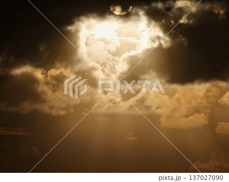 Lightning breaks through ominous cloud cover, Intense beam pierces stormy sky above turbulent waters 137027090