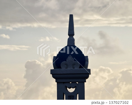 Lone tower at dawn, Lone spire against vivid dawn sky creates peaceful and reflective coastal scene 137027102