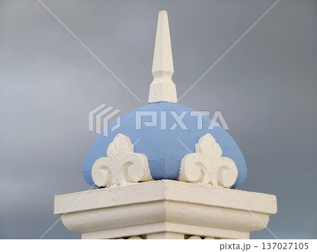 Skillfully crafted artistic image of decorative blue dome with finial beneath turbulent weather conditions Skillfully crafted artistic image of decorative blue dome with finial beneath turbulent weather conditions 137027105