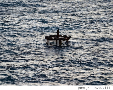 Weathered platform amid ocean waves, Nautical survey site with aged metal and ocean backdrop Weathered platform amid ocean waves, Nautical survey site with aged metal and ocean backdrop 137027111
