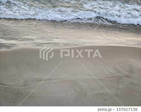 Serene beach setting, Tranquil beach environment featuring smooth ripples and soothing surroundings 137027136