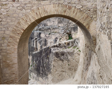 Solitary trekker navigates rugged cliffs through ancient sandstone passages with adventure and introspection 137027285