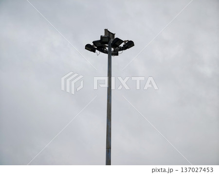 Sparse skyline featuring solitary lamp mast with metallic textures and industrial components 137027453