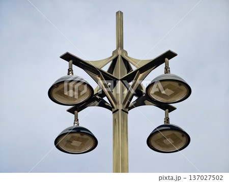 Sleek circular streetlamps with modern design, Stylish streetlight featuring round lamps and metal arms Sleek circular streetlamps with modern design, Stylish streetlight featuring round lamps and metal arms 137027502