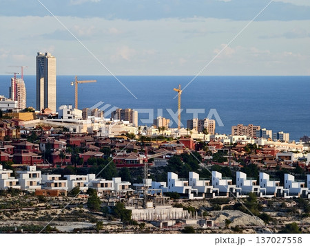 Coastline with towers and ocean, Hillside perspective capturing colorful buildings and waterfront scenery Coastline with towers and ocean, Hillside perspective capturing colorful buildings and waterfront scenery 137027558