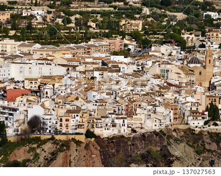 Overhead view reveals dense cluster of whitewashed homes on steep terrain with intricate alley patterns Overhead view reveals dense cluster of whitewashed homes on steep terrain with intricate alley patterns 137027563