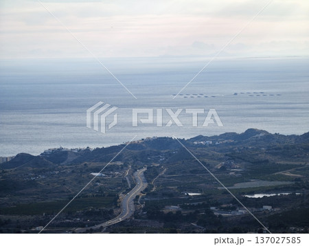 Serene aerial depiction of shoreline roads extending towards distant islands and rolling hills Serene aerial depiction of shoreline roads extending towards distant islands and rolling hills 137027585