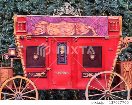 Rustic caravan adorned with intricate carvings and glowing lamps amidst festive environment 137027700