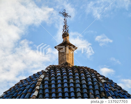 Dome with cross, Peaceful sunrise landscape showcasing church dome with cross and vibrant clouded sky 137027703