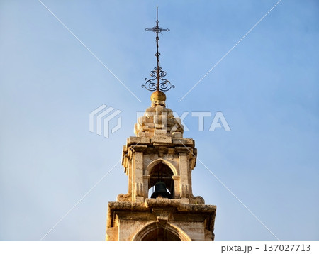 Bright tower symbolism, Golden bells evoke community memory, Sunlit church spire highlights cultural history Bright tower symbolism, Golden bells evoke community memory, Sunlit church spire highlights cultural history 137027713