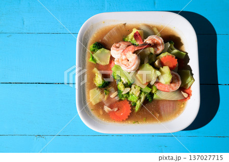 Shrimp and Vegetable Asian Stir Fry on Blue Wooden Table 137027715