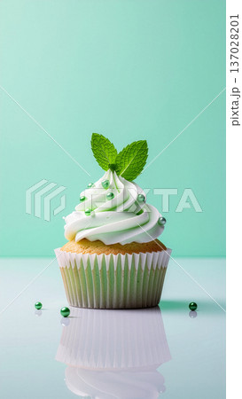 Light Green Frosting Cupcake with Mint Leaf Light Green Frosting Cupcake with Mint Leaf 137028201