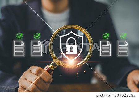 Professional examining cybersecurity with a magnifying glass, highlighting secure document management and data protection. Professional examining cybersecurity with a magnifying glass, highlighting secure document management and data protection. 137028283