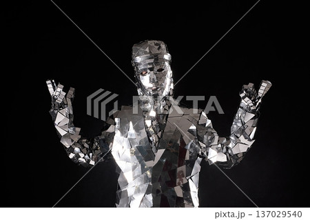 Reflective performer in a mirrored costume striking a pose on stage Reflective performer in a mirrored costume striking a pose on stage 137029540