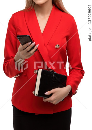 Professional woman in red blazer holding phone and wallet Professional woman in red blazer holding phone and wallet 137029602