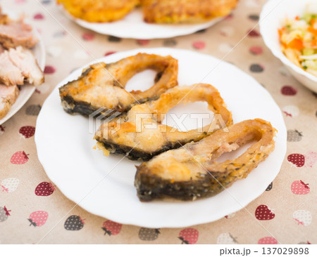 three pieces of fried carp on a white plate three pieces of fried carp on a white plate 137029898