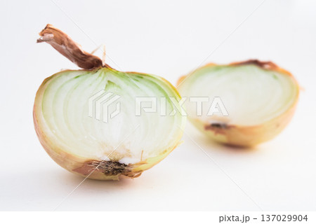 halves of ripe onions on black stone board halves of ripe onions on black stone board 137029904