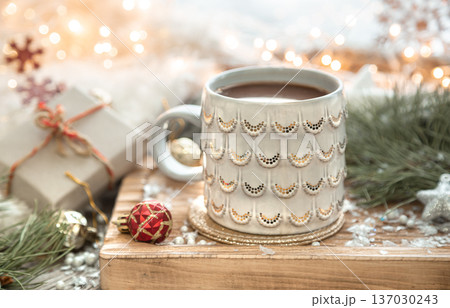 Christmas composition with a cup of coffee on a blurred background. Christmas composition with a cup of coffee on a blurred background. 137030243
