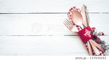 Christmas dinner cutlery on a white wooden background Christmas dinner cutlery on a white wooden background 137030281