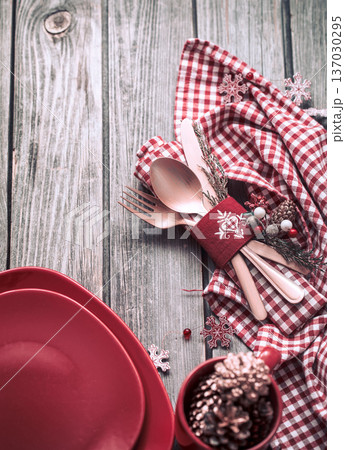 Christmas dinner cutlery with decor on a wooden background Christmas dinner cutlery with decor on a wooden background 137030295