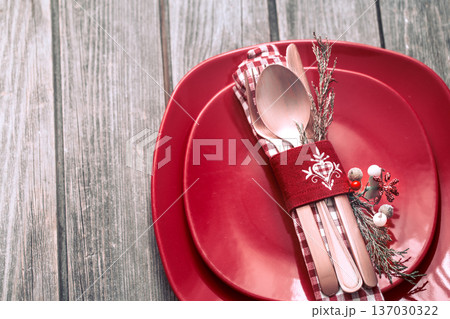 Christmas dinner cutlery with decor on a wooden background Christmas dinner cutlery with decor on a wooden background 137030322