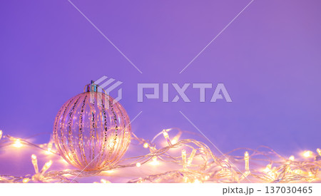 Christmas tree ball and garland in neon light isolated, copy space. 137030465