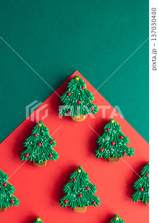 Christmas tree shaped gingerbread cookies covered with icing, flat lay. Christmas tree shaped gingerbread cookies covered with icing, flat lay. 137030480